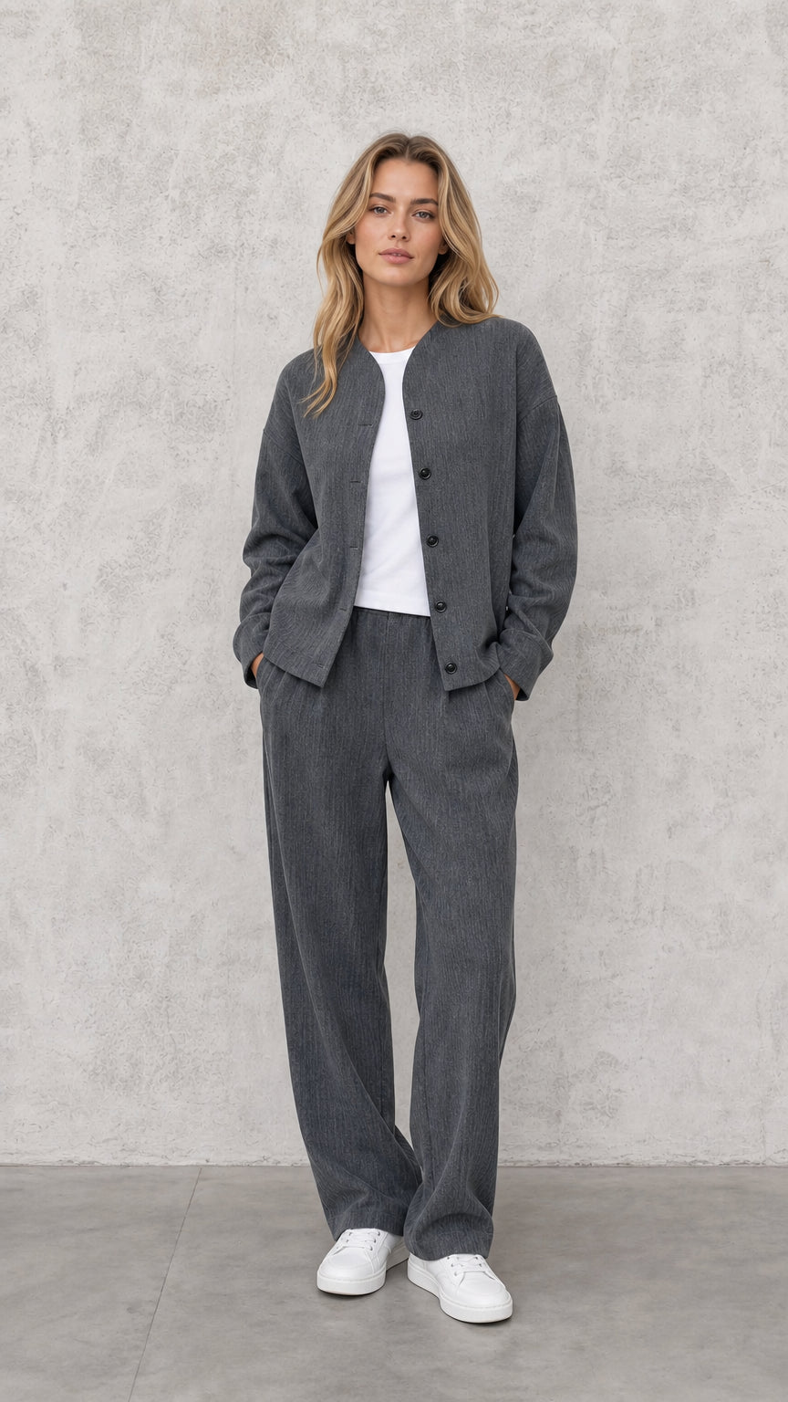Front view of model wearing Charcoal Grey textured two-piece jacket and wide-leg pant set