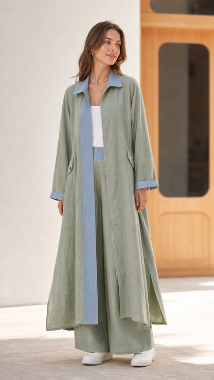 Full front view of sage green longline duster coat and wide-leg pants set with light blue contrast trim