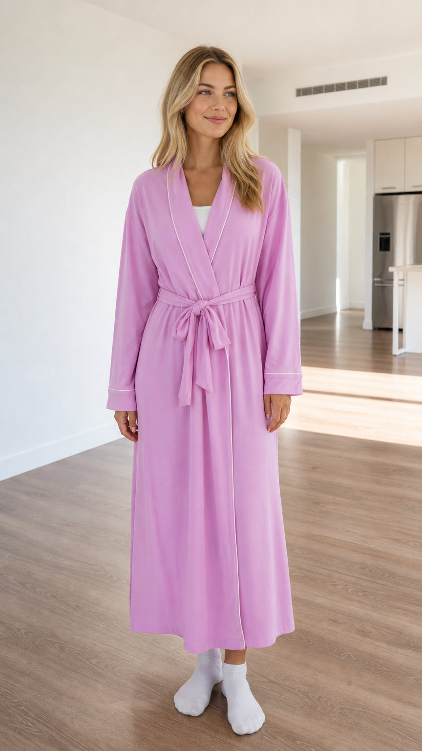 Front view of model wearing a lilac long knit robe with white contrast piping and tie belt
