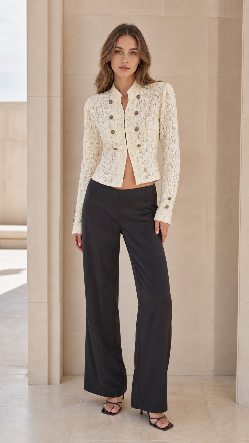 Front full view of woman wearing ivory lace military jacket with black trousers