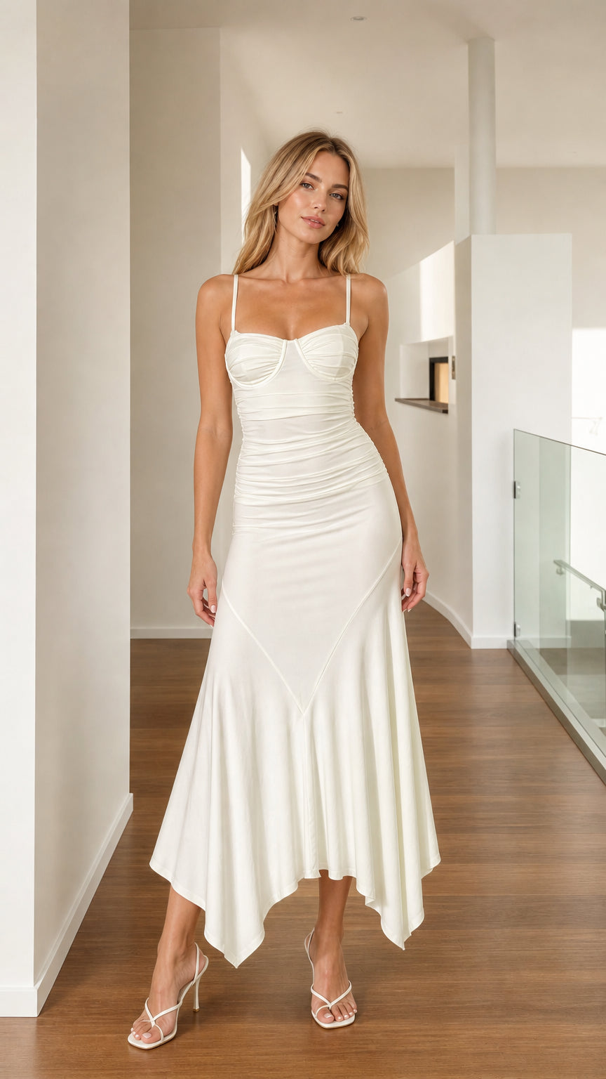 Front view of woman wearing white ruched asymmetrical midi dress