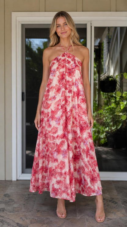 Front view of model wearing pink floral halter maxi dress