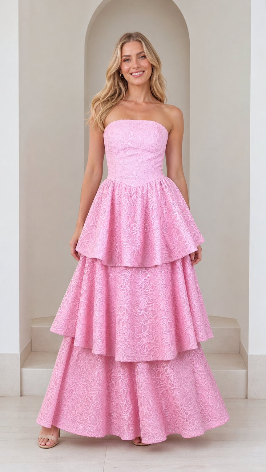 Front view of model wearing pink strapless tiered lace maxi dress