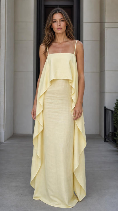 Front view of model wearing the yellow flowing overlay maxi dress