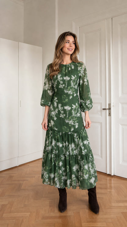 Woman wearing green floral print long sleeve tiered midi dress from the front