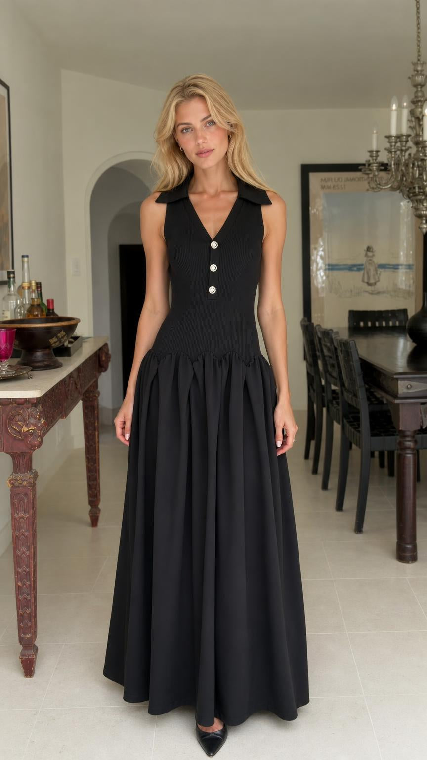 Front view of woman wearing black collared drop-waist maxi dress