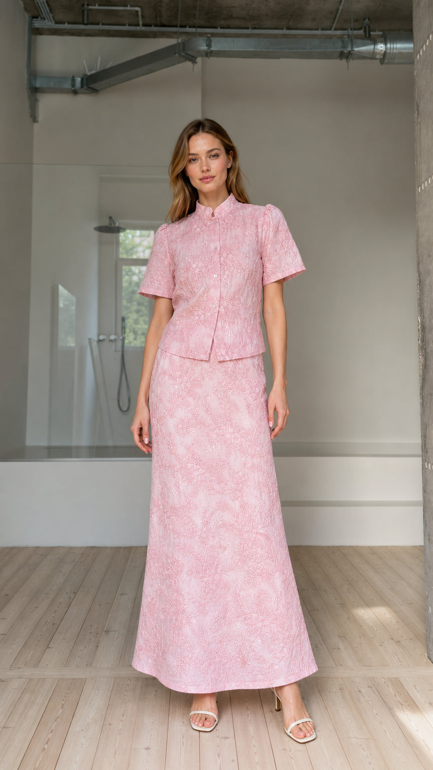 Front view of model wearing pink floral embroidered short-sleeve top and maxi skirt set