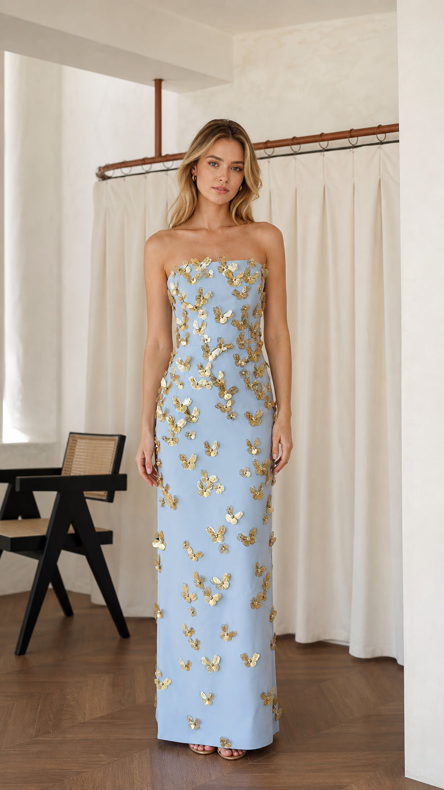 Front view of light blue strapless maxi dress with butterfly appliques