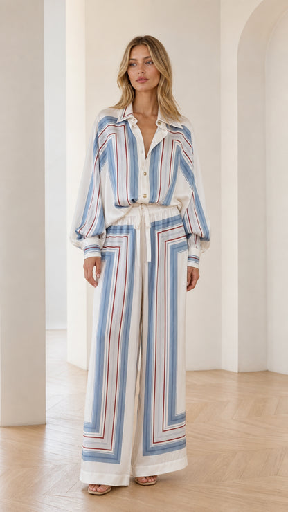 Front view of model wearing white geometric striped two-piece set