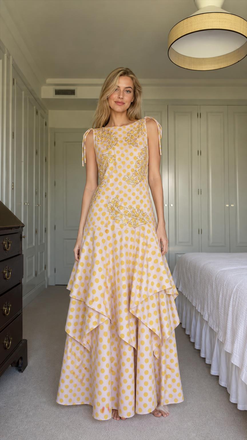 Front view of model wearing yellow polka dot tiered maxi dress