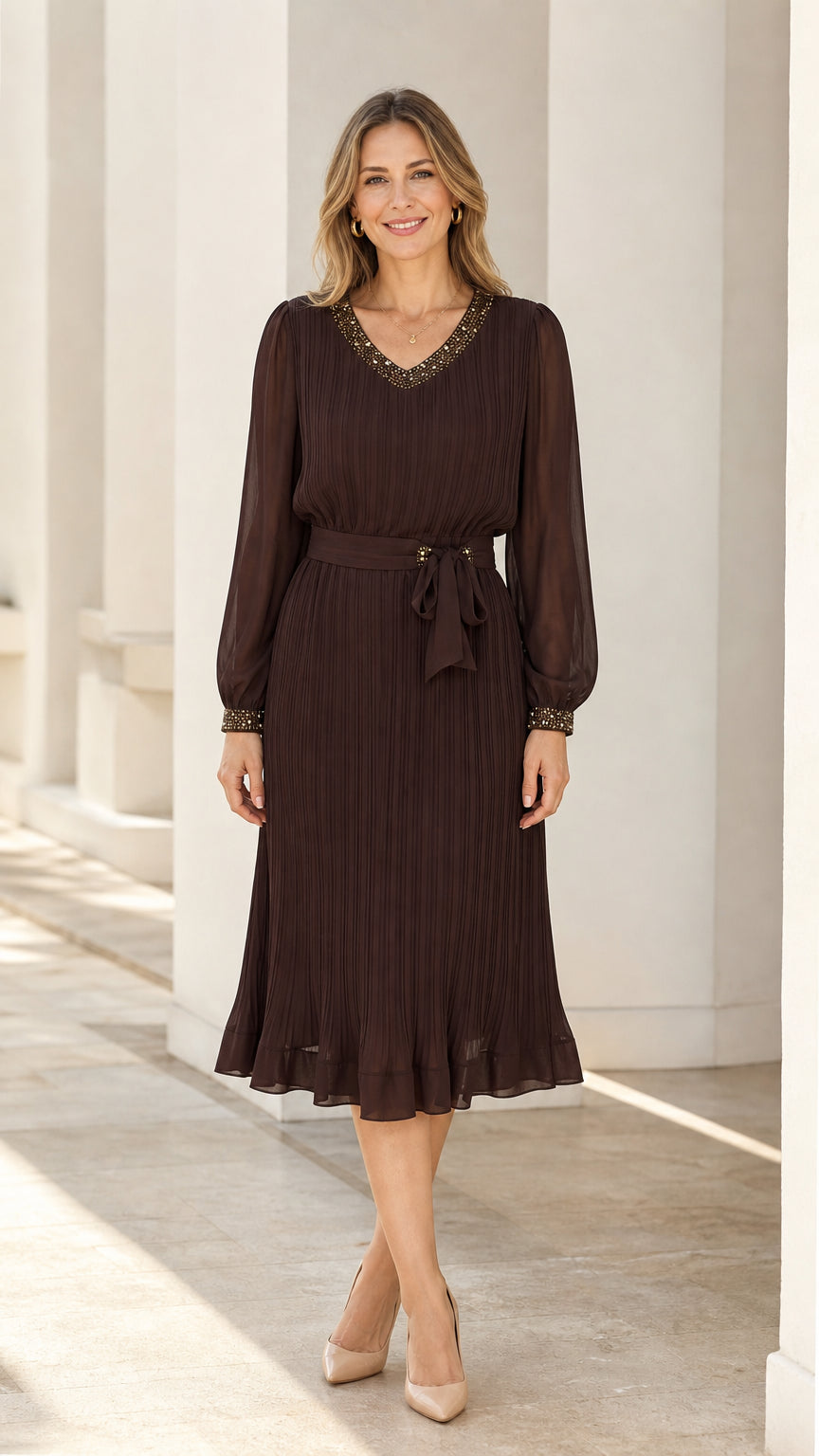 Front view of dark brown long sleeve pleated midi dress with beaded neckline
