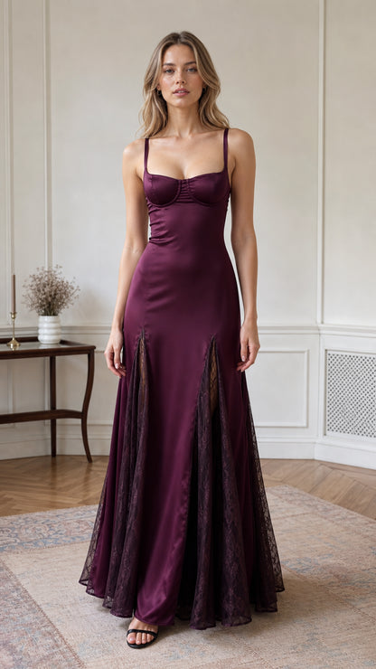 Front view of model wearing burgundy satin bustier maxi dress with lace inserts