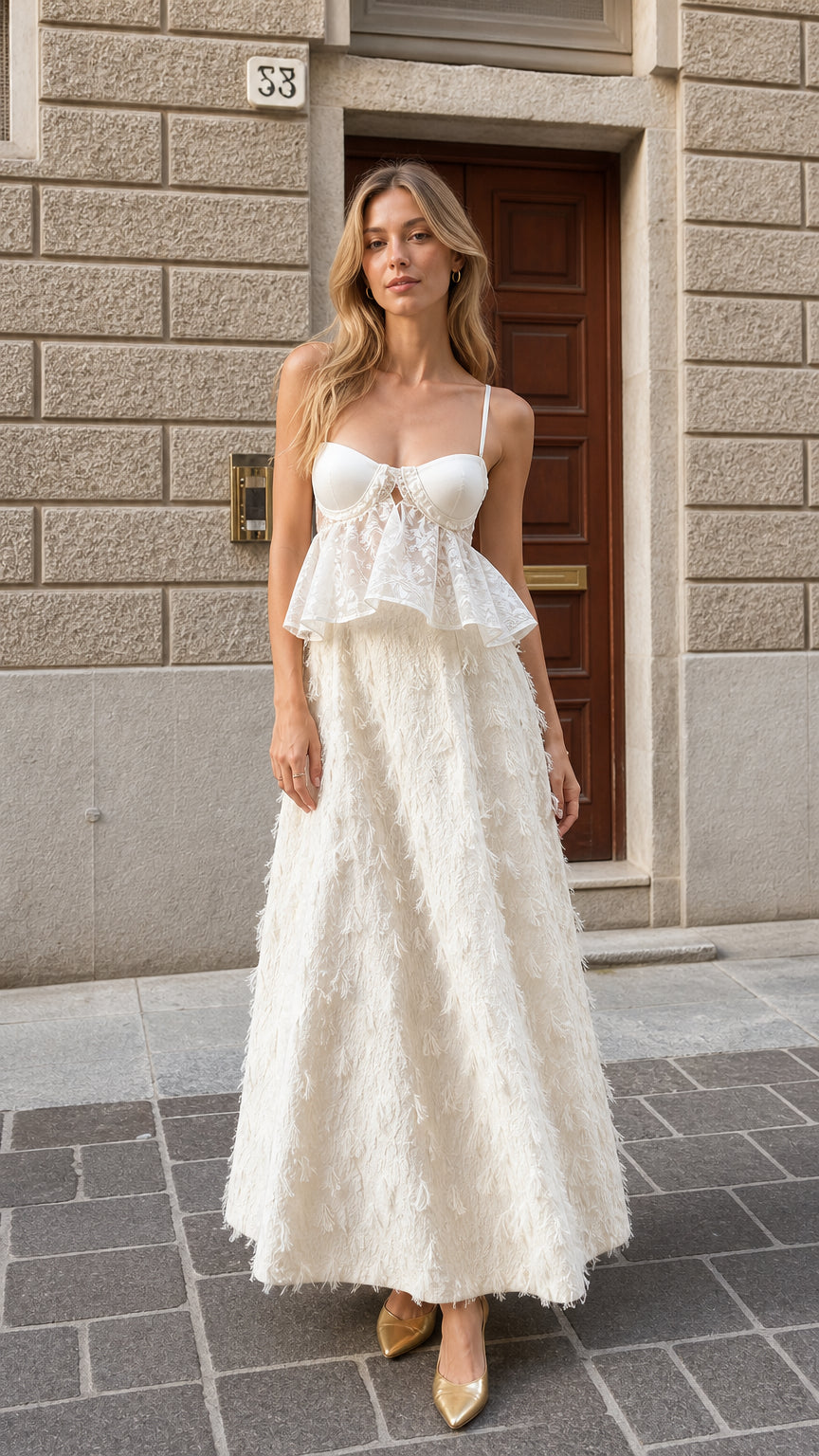Front view of woman wearing ivory white bustier lace peplum feather maxi dress