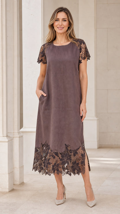Front view of model wearing taupe lace-trimmed midi dress with pockets