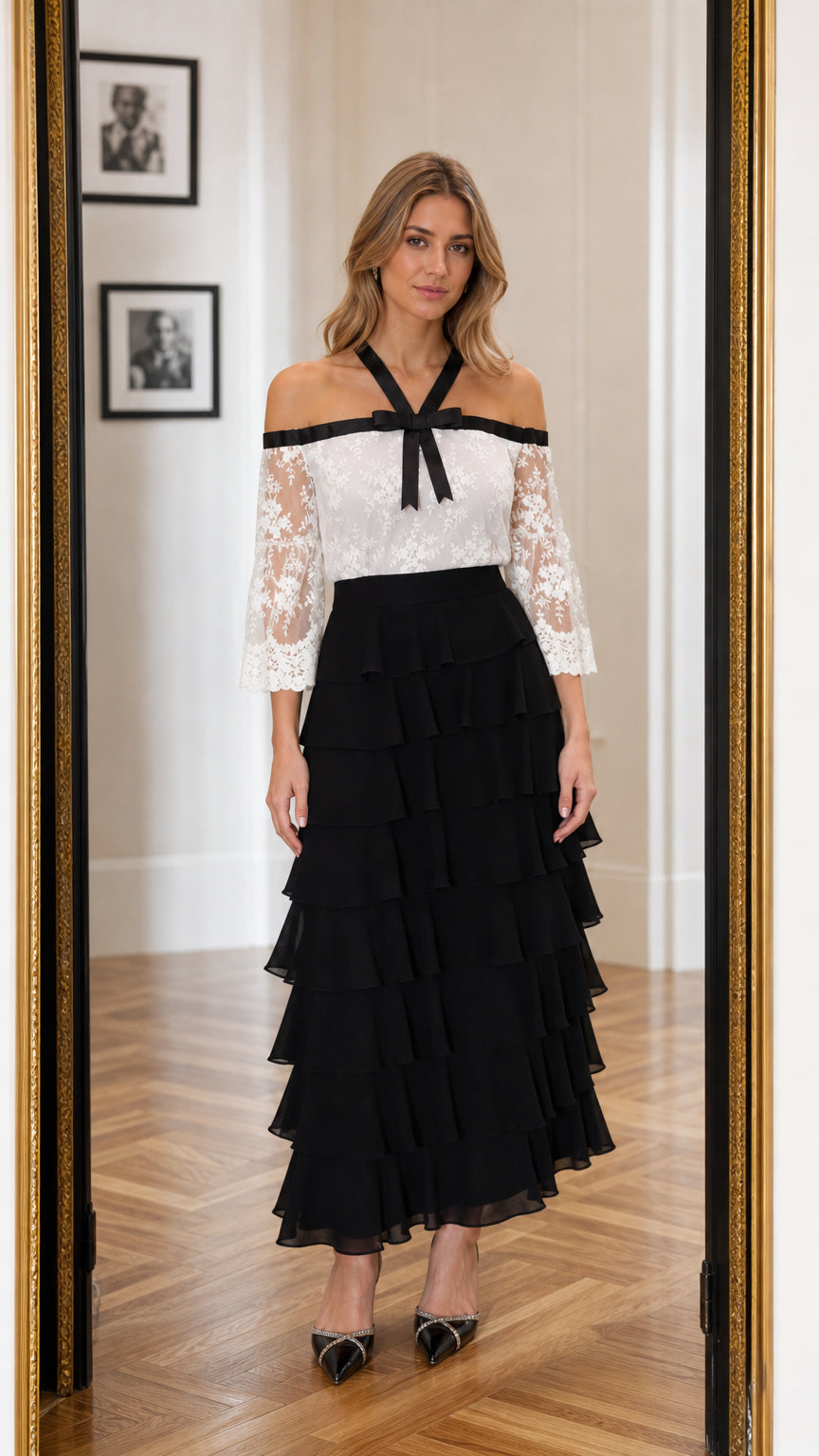 Front view of model wearing white and black off-the-shoulder lace tiered maxi dress