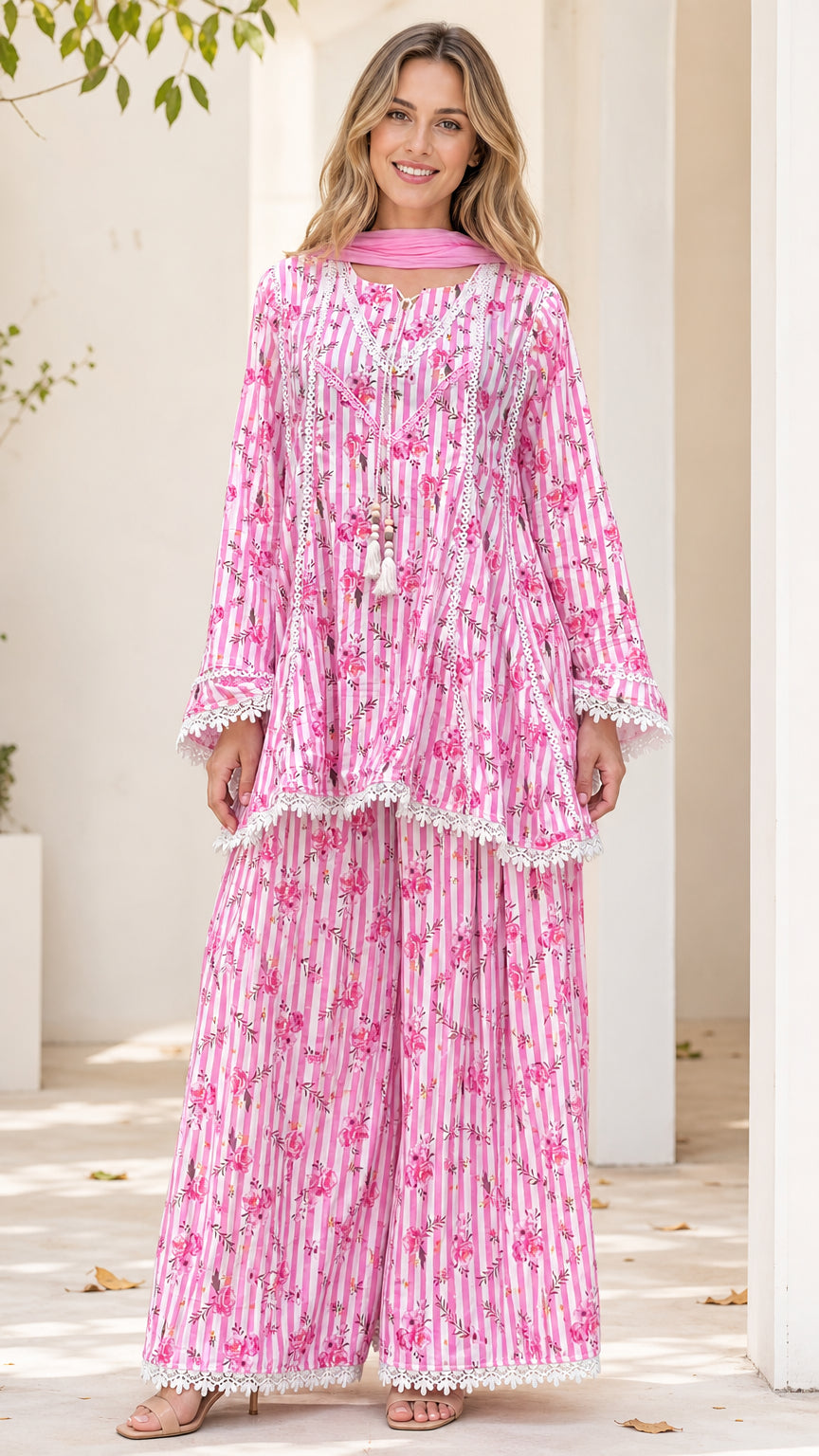 Front view of model wearing pink floral striped tunic and pants set with dupatta