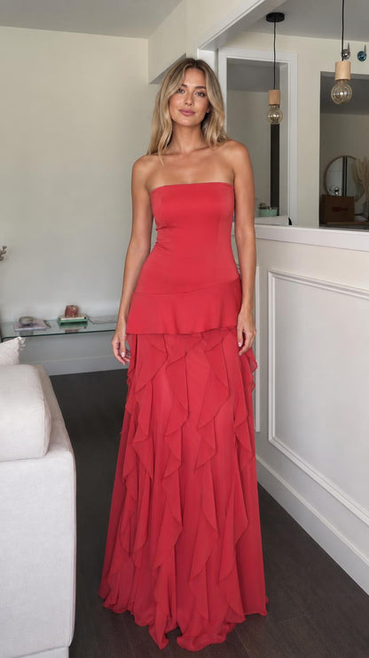 Front view of model wearing red strapless ruffle tiered maxi dress