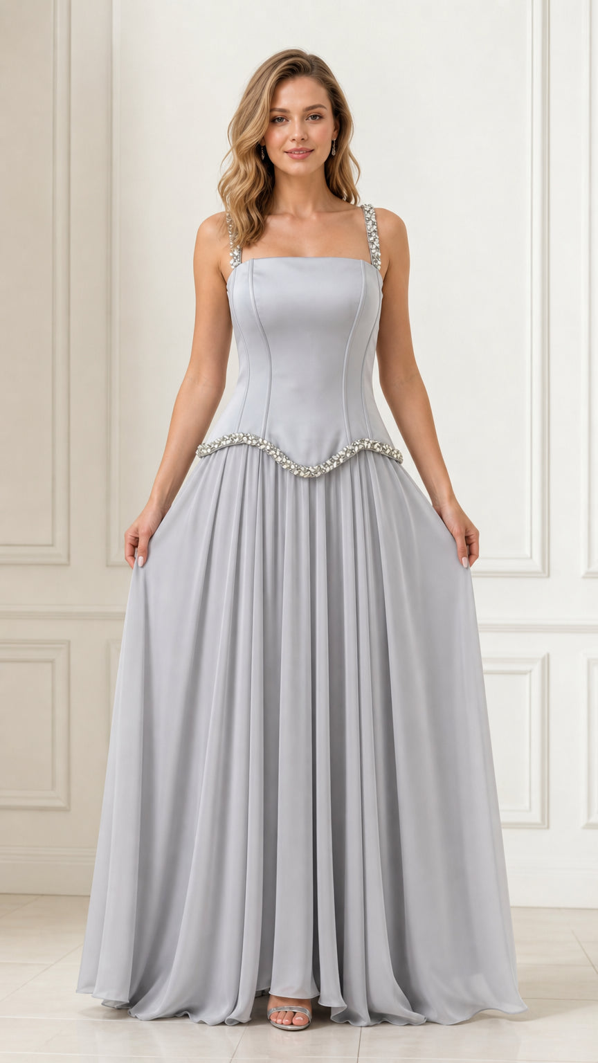 Full front view of a woman wearing a silver crystal-embellished chiffon evening maxi dress