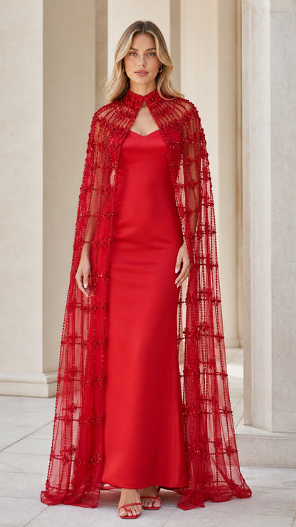 Front view of model wearing red beaded cape and evening dress