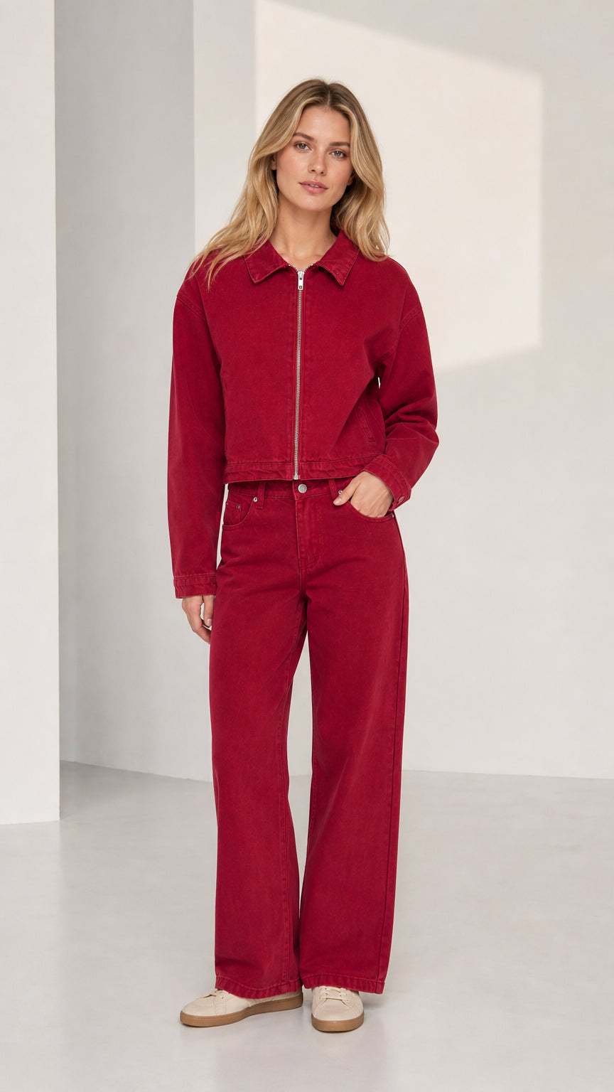 Woman wearing red denim zip-up jacket and wide-leg pants set, front view