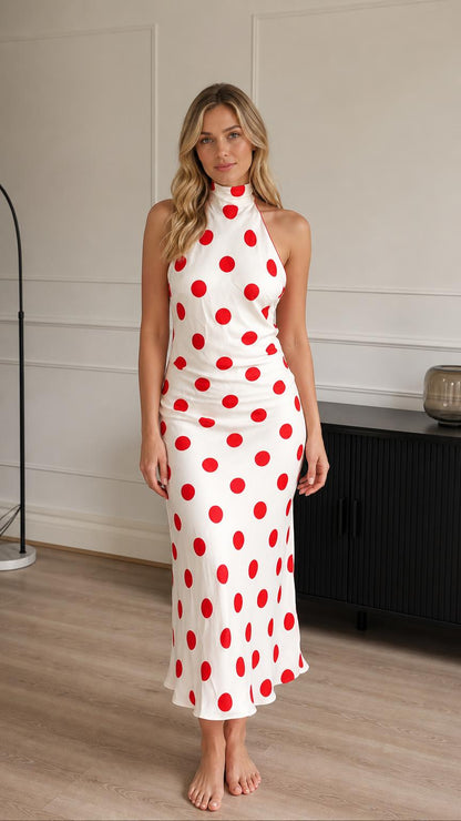 Front view of model wearing white and red polka dot halter midi dress