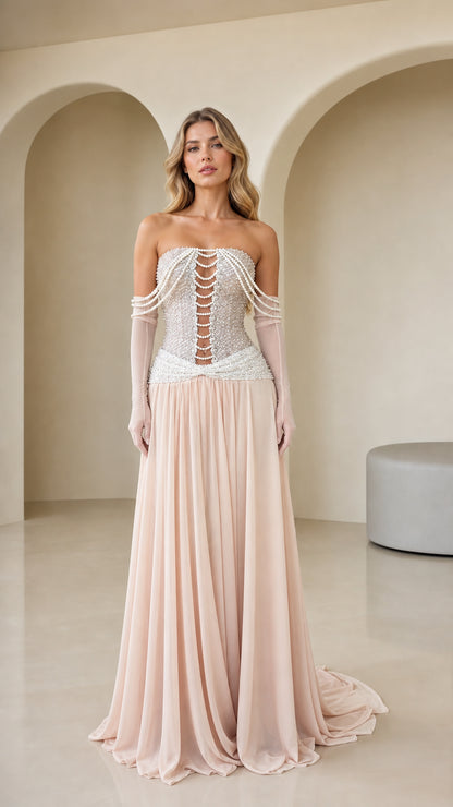 Front view of Blush Pink strapless evening gown with pearl corset bodice and flowing chiffon skirt