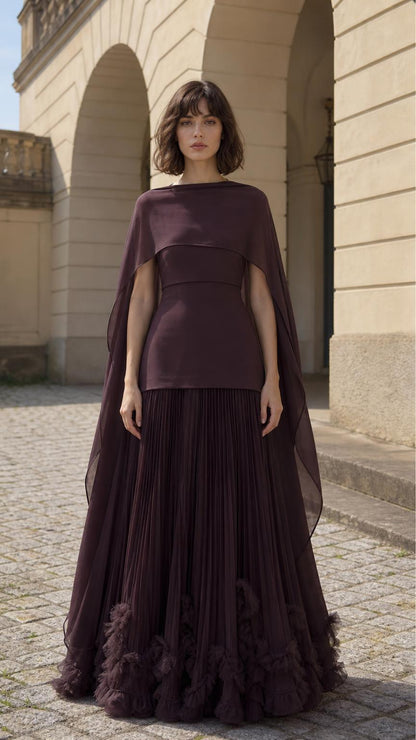 Front view of woman wearing plum cape overlay pleated maxi dress