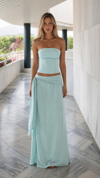 Front view of light blue strapless corset top and draped maxi skirt set