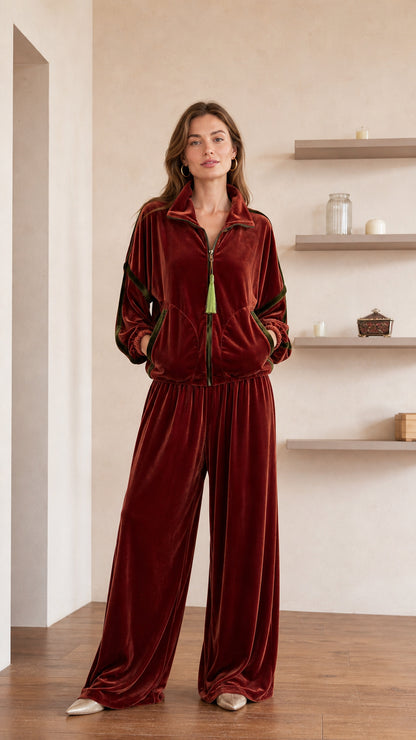 Front view of model wearing rust velvet track jacket and wide-leg pants set