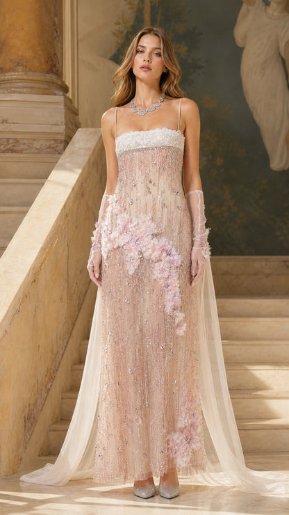 Front view of model wearing blush pink beaded maxi gown with cape
