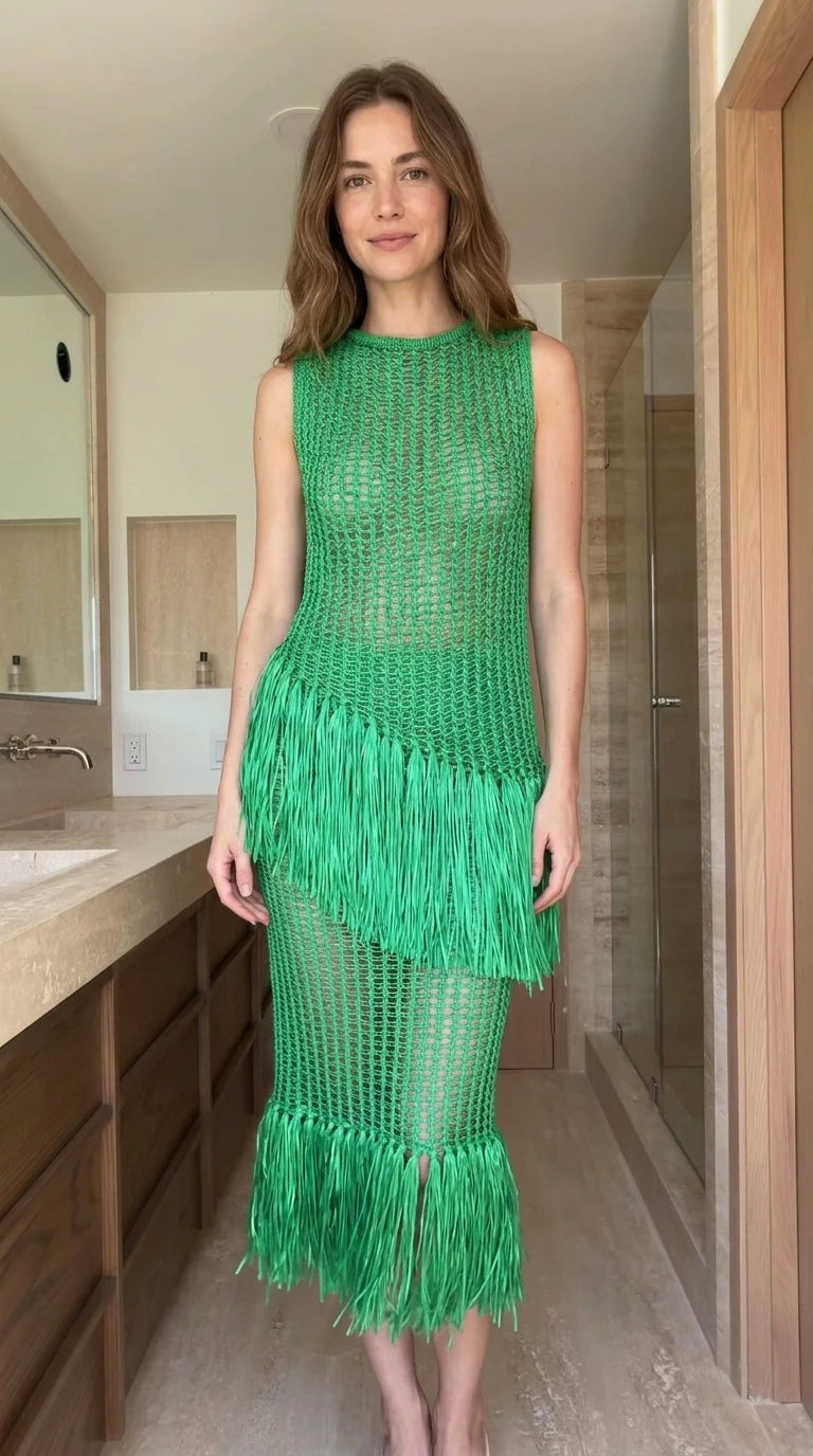 Front view of woman wearing green open-knit fringe midi dress