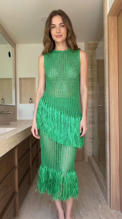 Front view of woman wearing green open-knit fringe midi dress