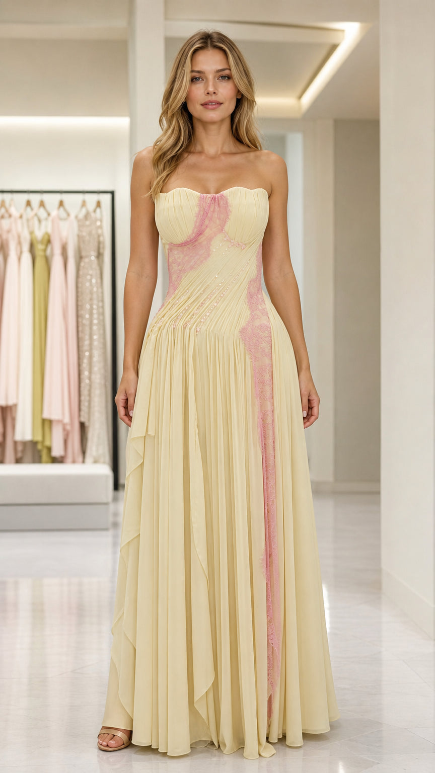 Front view of yellow strapless pleated evening gown with pink lace detail