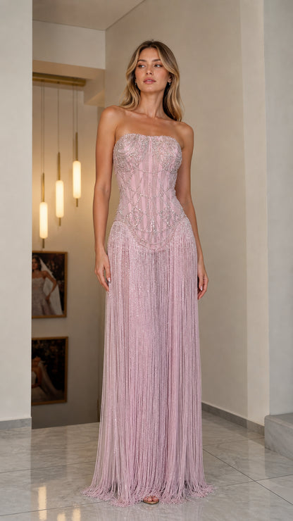Front view of model wearing pink strapless beaded fringe gown