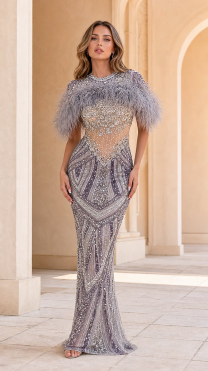 Front view of model wearing Slate Grey feather capelet beaded illusion evening gown
