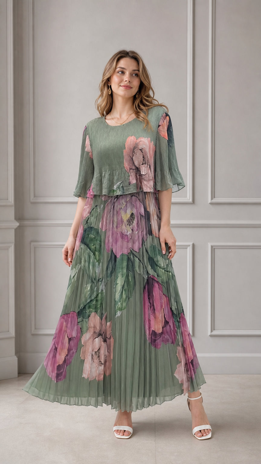 Full front view of model wearing sage green floral pleated maxi dress with layered overlay