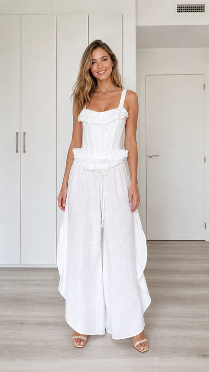 Model wearing white ruffled corset top and wide-leg pants set, front view