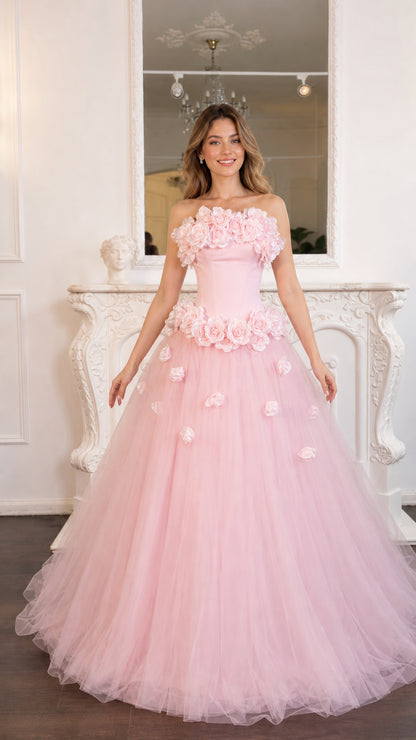 Front view of model wearing the pink 3D rose strapless tulle gown