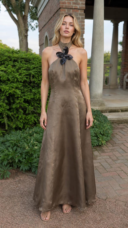Full front view of model wearing taupe satin halter maxi dress