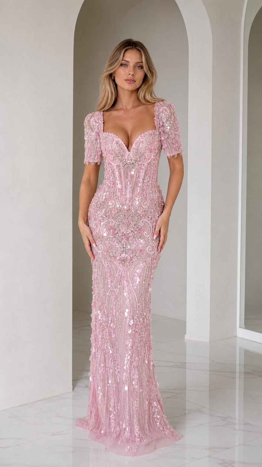 Front view of model wearing a blush pink beaded and sequined floor-length evening gown with short sleeves