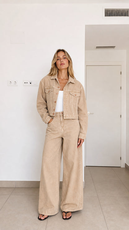 Front view of woman wearing beige cropped denim jacket and wide-leg pants set