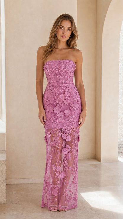 Front view of woman wearing strapless orchid pink 3D floral lace maxi dress with sheer hem