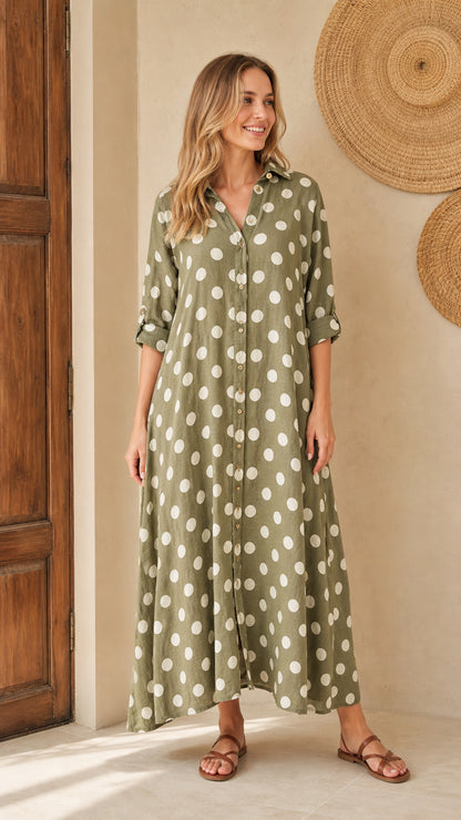 Front view of woman wearing olive polka dot maxi shirt dress with flat sandals