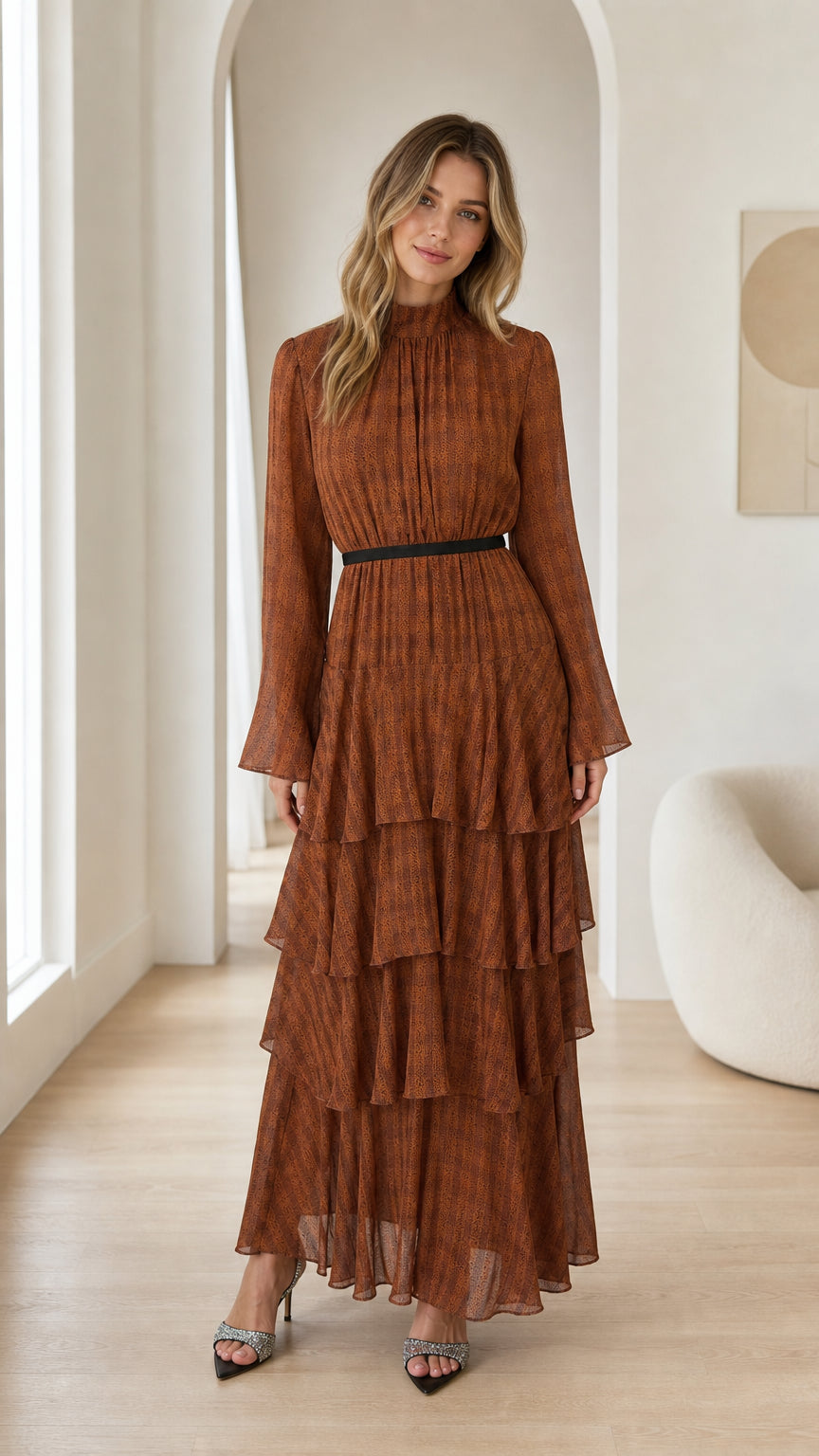 Front full view of woman wearing Rust Brown mock neck tiered ruffle maxi dress with contrast waistband