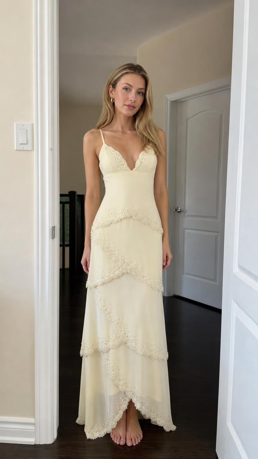 Front view of woman wearing yellow tiered lace maxi dress