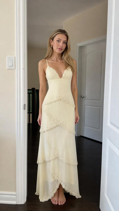 Front view of woman wearing yellow tiered lace maxi dress