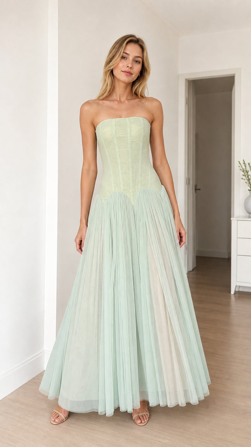 Model wearing sage green strapless corset tulle maxi dress, front view