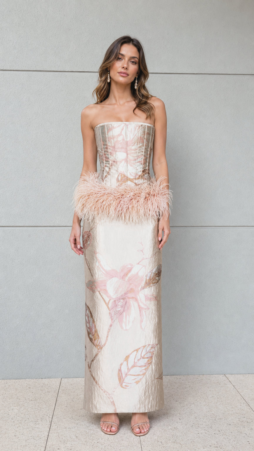 Full front view of champagne strapless jacquard corset maxi dress with feather hip trim