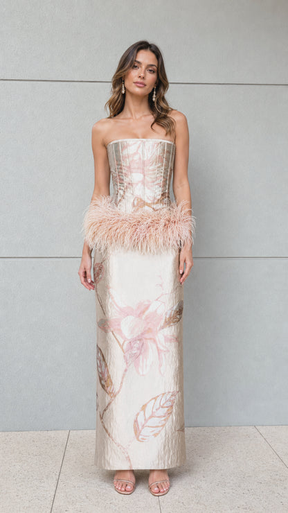 Full front view of champagne strapless jacquard corset maxi dress with feather hip trim