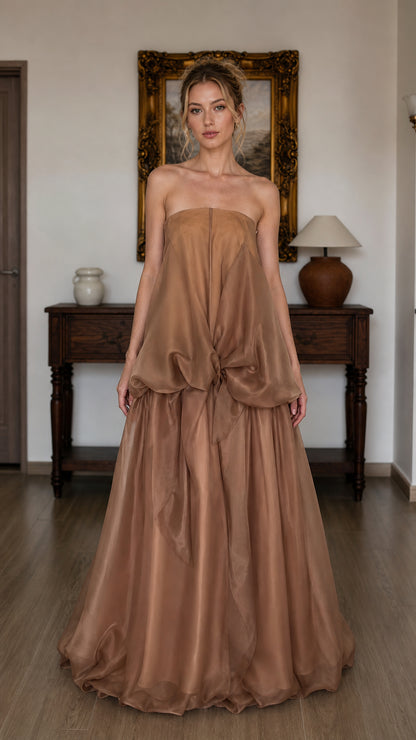 Front view of model wearing brown strapless tiered maxi dress